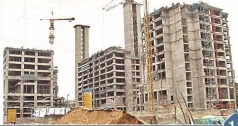 Residential towers under construction with a crane on site