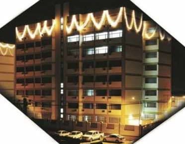 Hostel building lit for an evening event