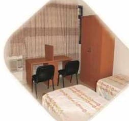 Student room with desk and bed