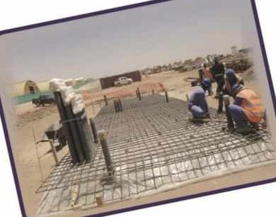 Crew fixing rebar for a telecom site foundation